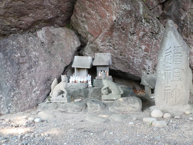 Dosojin wayside shrine with stone fox guardians and miniature hokora, Maebashi, Gunma, Japan